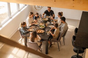 A family dining at a table with a view of the outdoors. - Spa & Lake | Orphee (Chertsey)
