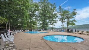 A pool area with multiple swimming pools, lounge chairs, and trees. - Fall Foliage, Hiking Trails, Close to Jim Thorpe! (Lake Harmony)