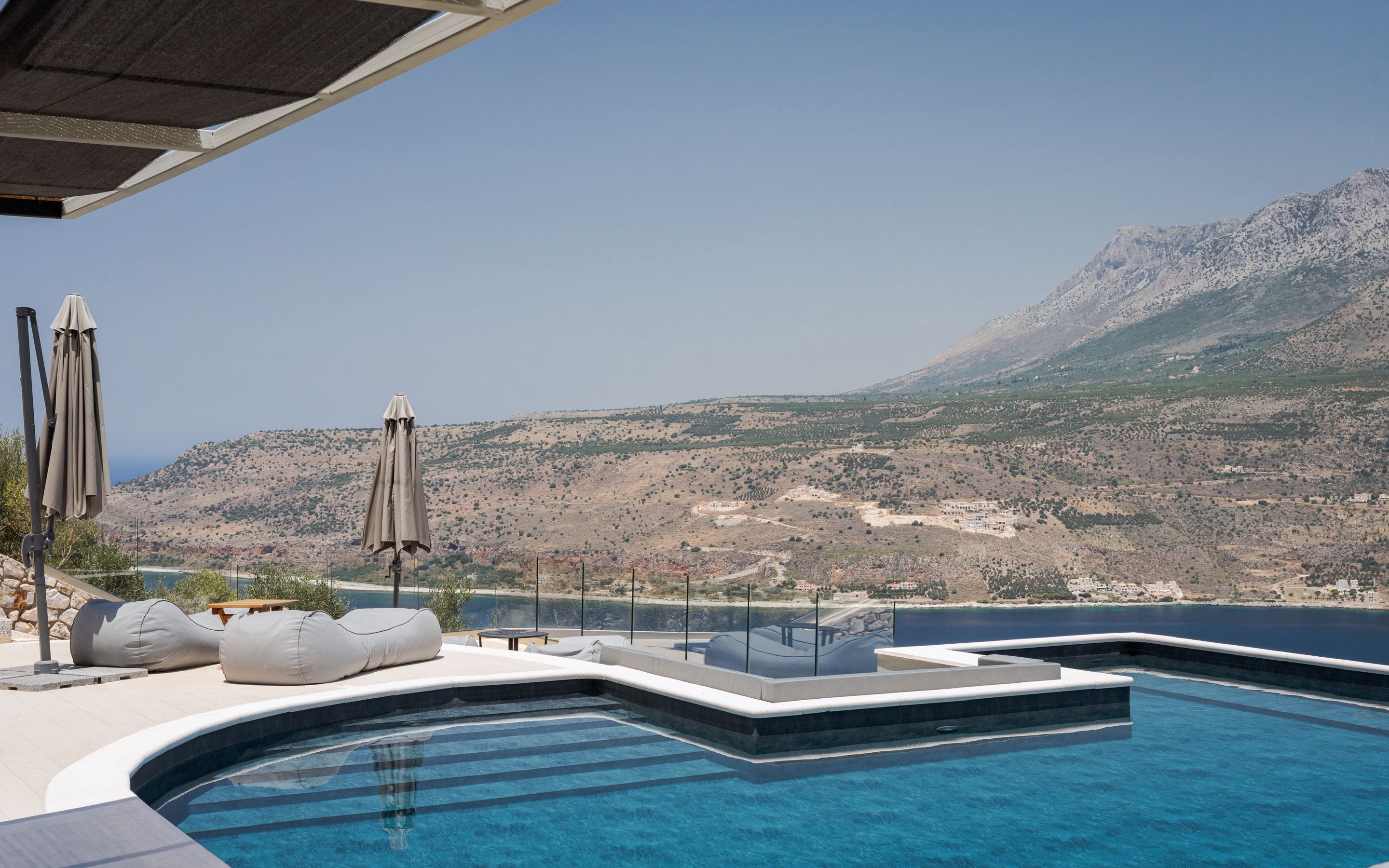 A pool area with a view of a mountainous landscape.