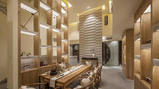 A modern dining area with a long wooden table and chairs, surrounded by wooden partitions and shelves with various items. - Ibis Chengdu Gaoxin Tianfu Software Park Hotel (Chengdu)