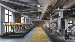 A modern gym with treadmills lined up on one side and weight machines on the other. - Ibis Chengdu Gaoxin Tianfu Software Park Hotel (Chengdu)
