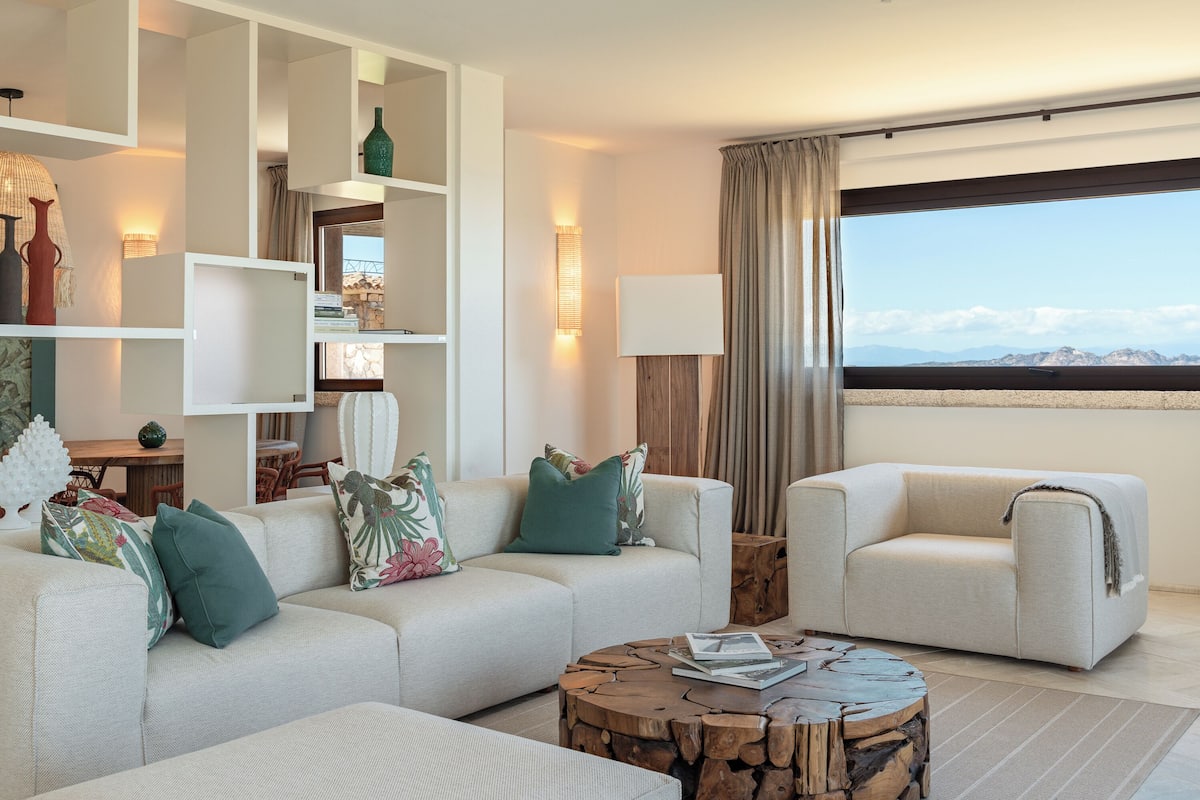 Deluxe Suite, 2 Bedrooms | Living area | 50-inch Smart TV with digital channels, first-run movies