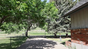 A gravel path leading to a brick building with a metal roof. - Good Decision on the Mo- Cascade, MT (Cascade)