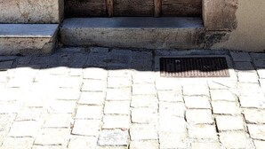 A large wooden door with a plaque, set within a stone archway. - The Charm of Anduze (Anduze)