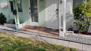 A house with a front porch, a door labeled "1408", and a number "3" on the wall.