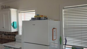 A kitchen with white cabinets, a white refrigerator, and a stove. - Oceanfront 2 bedroom house with WiFi in Freeport on 45 acres. (Freeport)