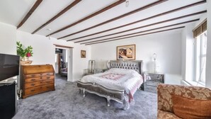 A bedroom with a large bed, a dresser, a TV, and a window. - 4/5 Bed-2 Bath-bar-pool Table-library-parking For7 (Dorchester)
