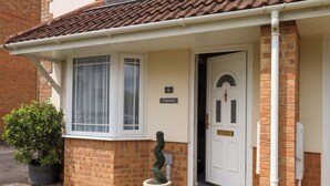A house with a white door, a number plate, and a small garden. - Hedgehogs (Barnstaple)