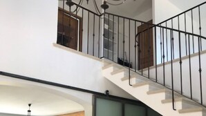 A spacious living area with a staircase leading to an upper floor. - Mas Joseph amid vineyards and olive groves, 7 minutes from downtown Aix-en-Provence (Venelles)