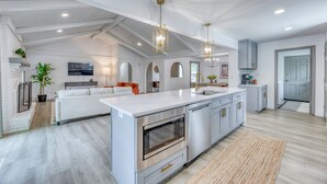 A spacious kitchen with a large island, stainless steel appliances, and pendant lighting. - Upscale Fishers Getaway/Hot Tub/Peaceful/Quiet! (Fishers)