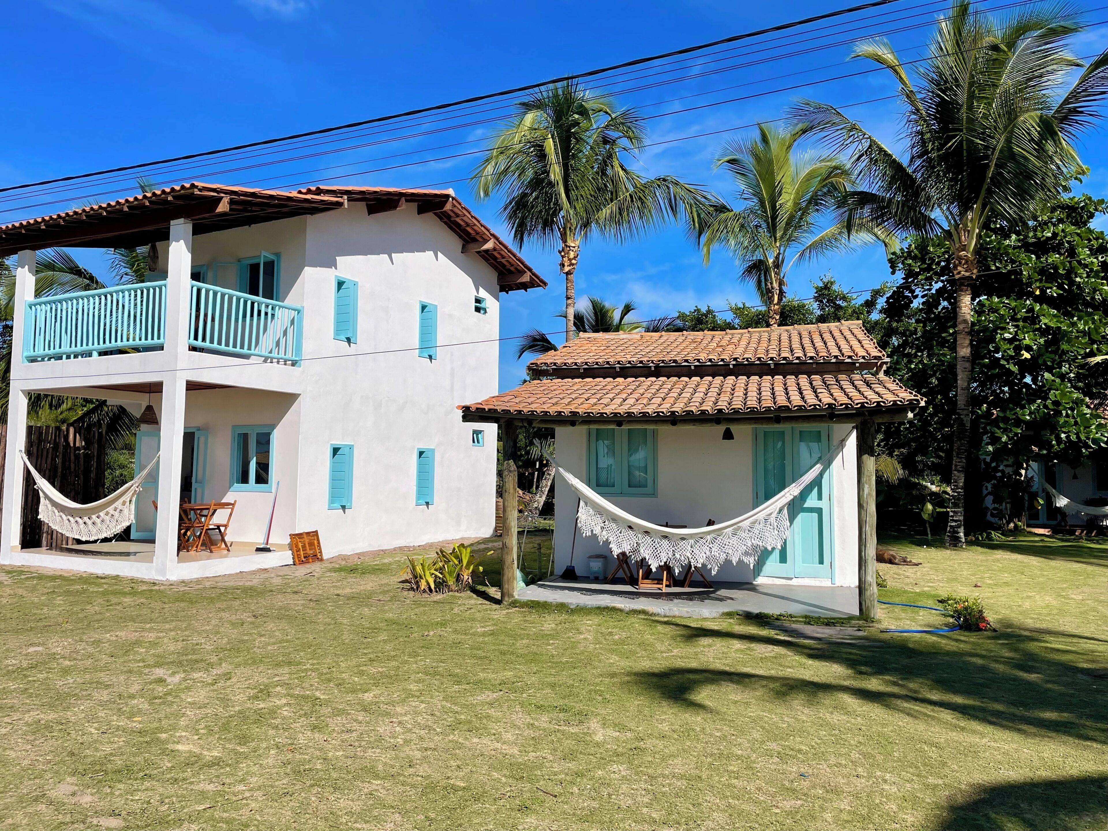 A two-story building with a balcony and a hammock.