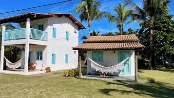 A two-story building with a balcony and a hammock.