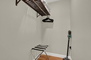 A room with a ceiling-mounted drying rack, a vacuum cleaner, and a wall-mounted shelf. - Casita Atala - Nestle into a Tropical Designer Retreat with Shared Pool (West Palm Beach)