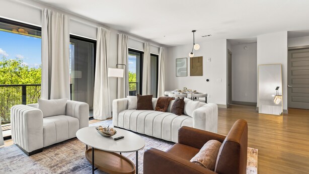 A modern living room with a sofa set, a coffee table, and a dining area with a table and chairs. - Lux Mocha Downtown Self Check-in Balcony (Atlanta)