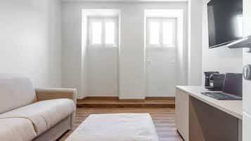 Deluxe Suite, Balcony, City View | Living room | 55-inch Smart TV with digital channels, Netflix, streaming services