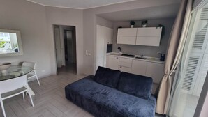A compact living space with a kitchenette, a dining area, and a sofa. - Tracadero Marina 49 Apt, 1 Hab. (Dominicus)