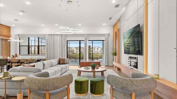 A modern living room with a sofa, two armchairs, a coffee table, and a TV mounted on the wall. - HOGWARTS HEAVEN! Epic Private Theater! Mickey, Mario & Princess! (Orlando)