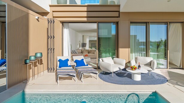 A modern outdoor pool area with lounge chairs, a sofa, and a dining table. - Beautiful home in Turanj (Turanj)
