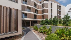 A modern multi-story building with balconies and a landscaped garden area. - URBAN PENTHOUSE by Azores HomeMade (Ponta Delgada)