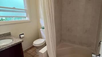 Separate tub and shower, towels, soap, shampoo