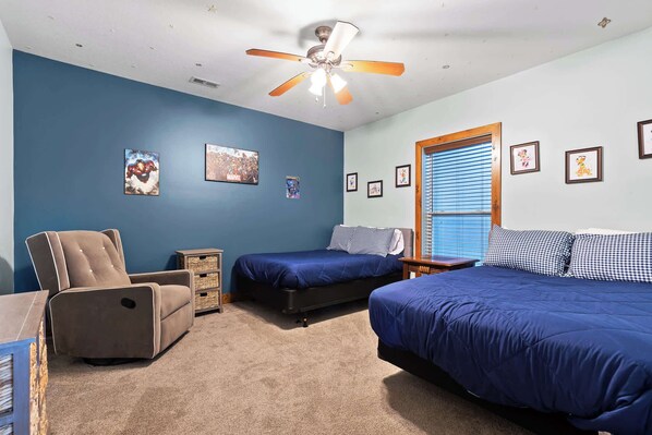 A bedroom with two beds, a ceiling fan, and wall art. - Updated Cabin - Hiwassee Highlife (Decatur)
