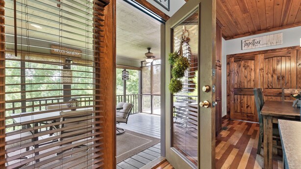 A wooden interior with a sliding glass door leading to an outdoor deck. - Updated Cabin - Hiwassee Highlife (Decatur)