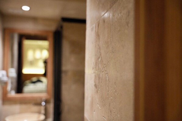 A hallway with a marble column and a blurred background suggesting a hotel interior. - Khalkedon Suites (Istanbul)