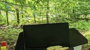 An open portable grill with two slices of bread on the grates, set on a wooden surface outdoors. - Turey Forest Camping Near Bethel Woods - 15 minutes to Bethel Woods, Casino, (Harris)