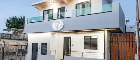 A modern two-story building with a sign reading 'CASA TAPIA.'