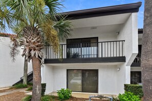 A two-story building with a balcony, a staircase, and a palm tree. - Edgewater Villas #2108 - 2 Bedroom/2Bath Sleeps 8.  Free Fun! (Panama City Beach)