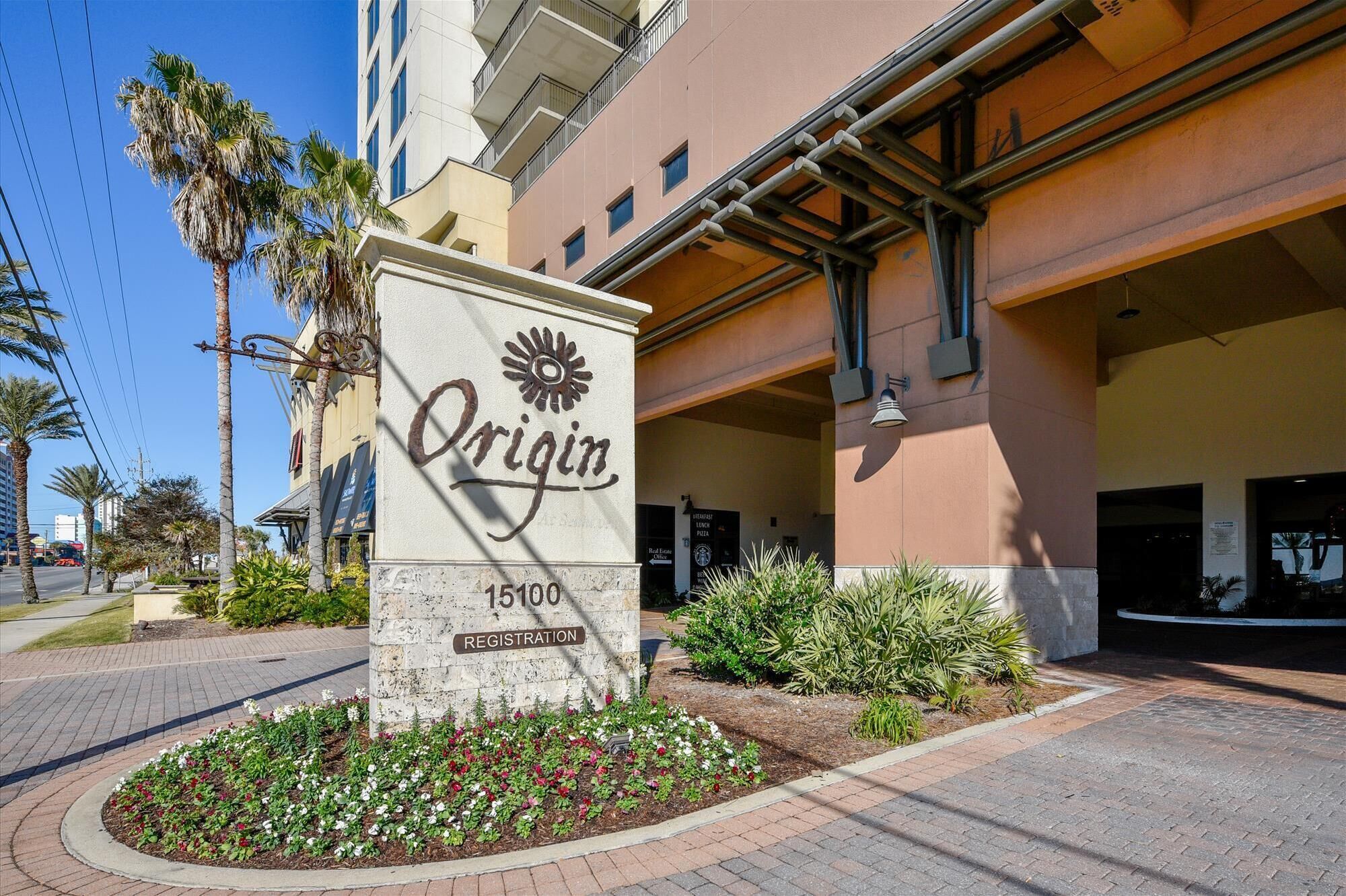 A hotel sign with the name 'Origin' and a registration number '15100'.