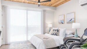 A modern hotel room with a bed, massage chairs, and artwork on the wall. - Kordeluxe Row #3 Studio Townhouse (Cedar City)