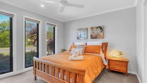 A bedroom with a wooden bed, a nightstand, and two paintings on the wall. - Apres - Dog Friendly (Mansfield)