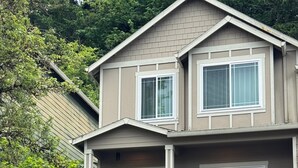 A two-story house with a front porch, a staircase, and a garage.