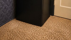 A compact black refrigerator and microwave unit with a potted plant and a roll of paper towels on top. - Charming 2-bedroom apartment in delightful Dearborn - no kitchen and no shower (Dearborn)