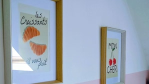 Two framed artworks on a wall, one depicting croissants and the other cherries. - LES COMBLES DE PIERRE 6, Bollaert, Fac, 1pers, parking (Lens)