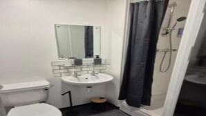 A compact bathroom with a toilet, sink, and shower. - Sandard Room In Town Centre (Middlesbrough)