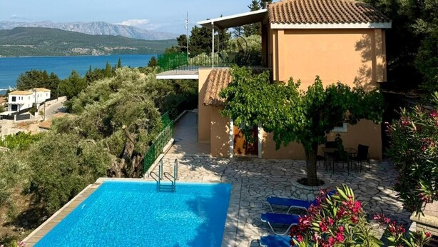A pool area with a clear view of the sea and mountains in the background. - Villa 'Melikokia' with Sea View, Wi-Fi and Air Conditioning (Unknown)