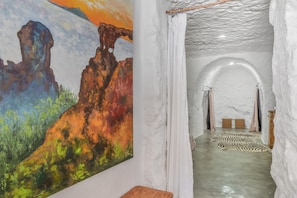A room with a painting of a landscape, a white textured ceiling, and a zebra-patterned rug. - 'Casa Cueva' with Mountain View, Private Terrace and Private Garden (Juncalillo)