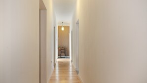 A narrow hallway with wooden flooring and white walls, leading to a room with a sewing machine. - Holiday Home 'Picarus' with Private Terrace, Wi-Fi, Air Conditioning & Heating (tacoronte)
