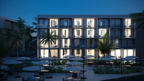 A modern hotel with multiple balconies, outdoor seating, and a pool area. - Porto Alto Resort, The best option for your vacation! (N. São do Ó)