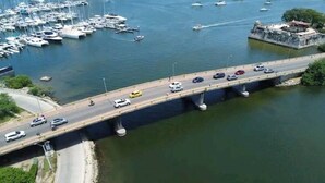 A bridge over a body of water with multiple lanes of traffic and a marina in the background. - 2 bedroom apartment - Manga Cartagena Colombia (Cartagena de Indias)