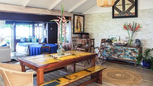 A spacious room with a large wooden dining table, comfortable seating, and a rustic decor.