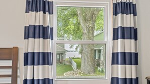 A window with a view of a tree and a house.