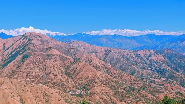 A mountainous landscape with terraced fields and a small settlement. - Anurag Hotel Chakrata  (Kalsi)