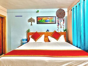 A bed with a wooden headboard, white bedding, and red and gold accents. - Anurag Hotel Chakrata  (Kalsi)