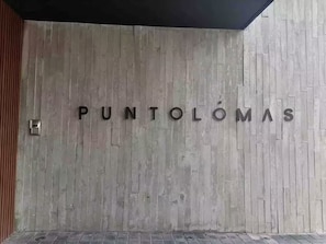 Un mur sur lequel est inscrit le texte « PUNTOLÔMAS » en grandes lettres.