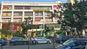 A multi-story building with a prominent sign for Hotel Krishna Park. - Hotel Krishna Park  (Ahmedabad)