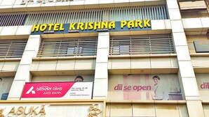 A building with the sign "HOTEL KRISHNA PARK" and "AXIS BANK" on the facade. - Hotel Krishna Park  (Ahmedabad)
