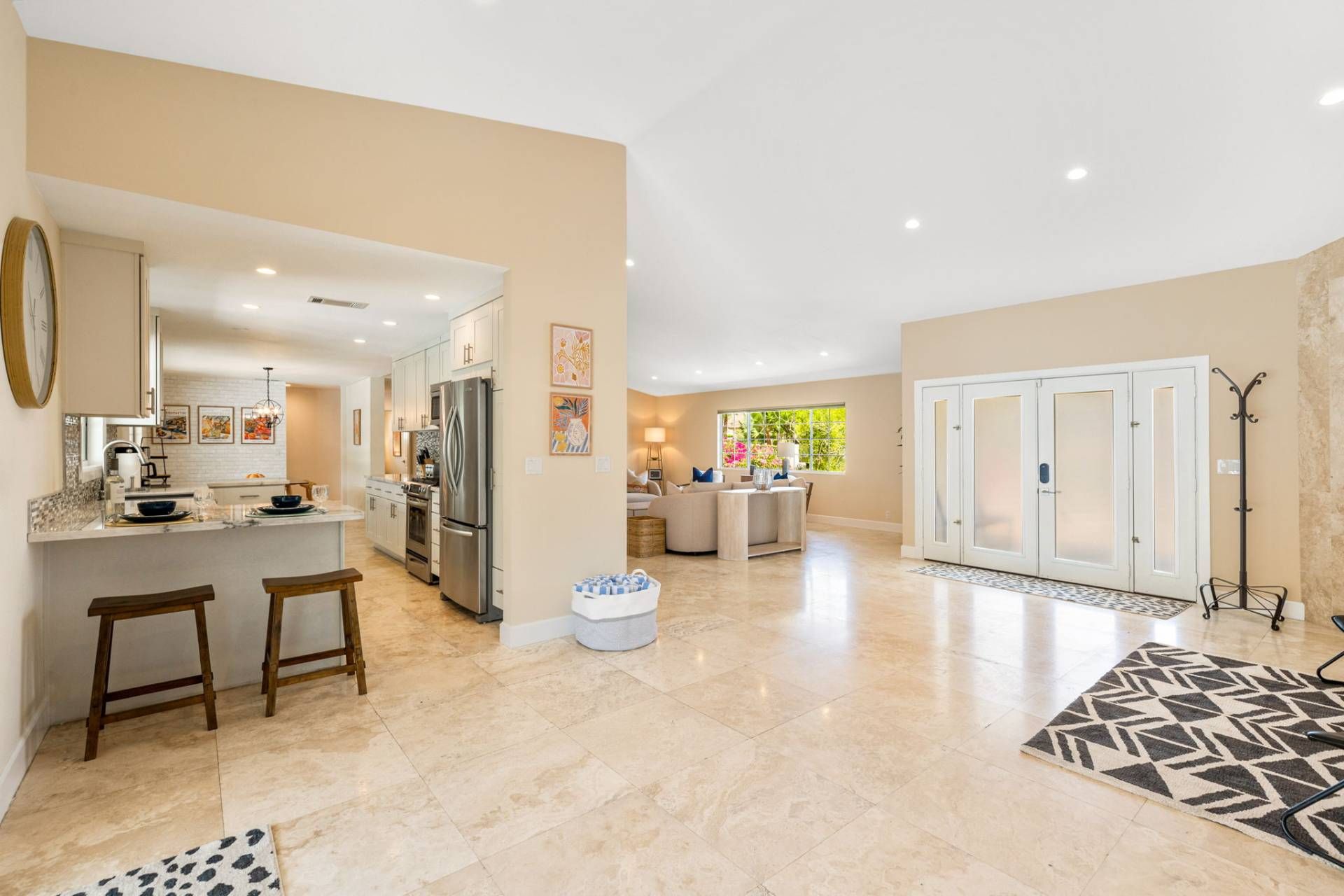 A spacious living area with a kitchen, a dining area, and a large wardrobe.